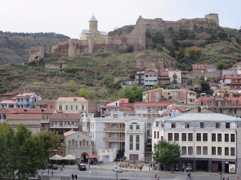 Tbilisi with old town buildings climbing toward the castle walls