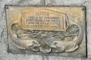 The plaque on the pedestal 