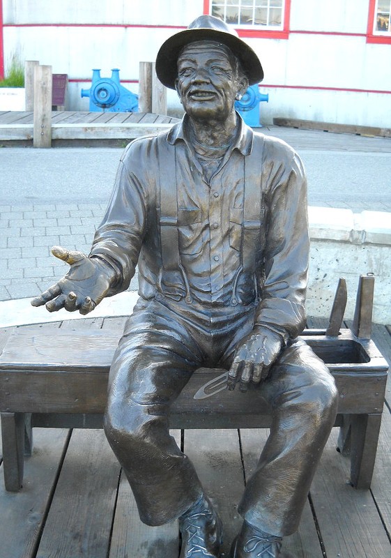 Elderly fisherman sitting on a net mending bench