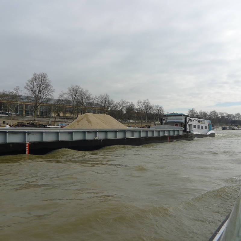 Long Cargo Barge With A Load Of Sand