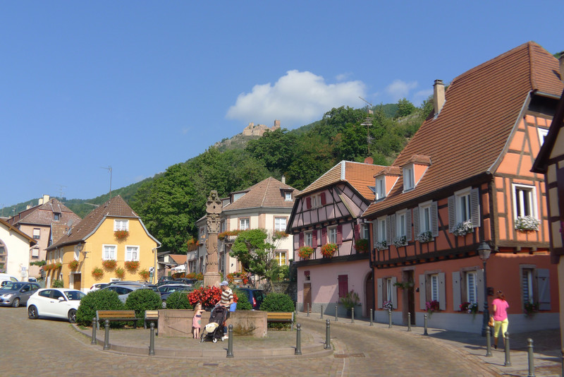 Village with Saint-Ulrich Castle in the distance .