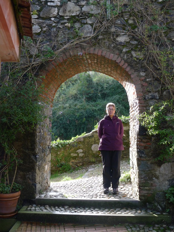 Sue in a medieval archway leading from the Church to the Castle.