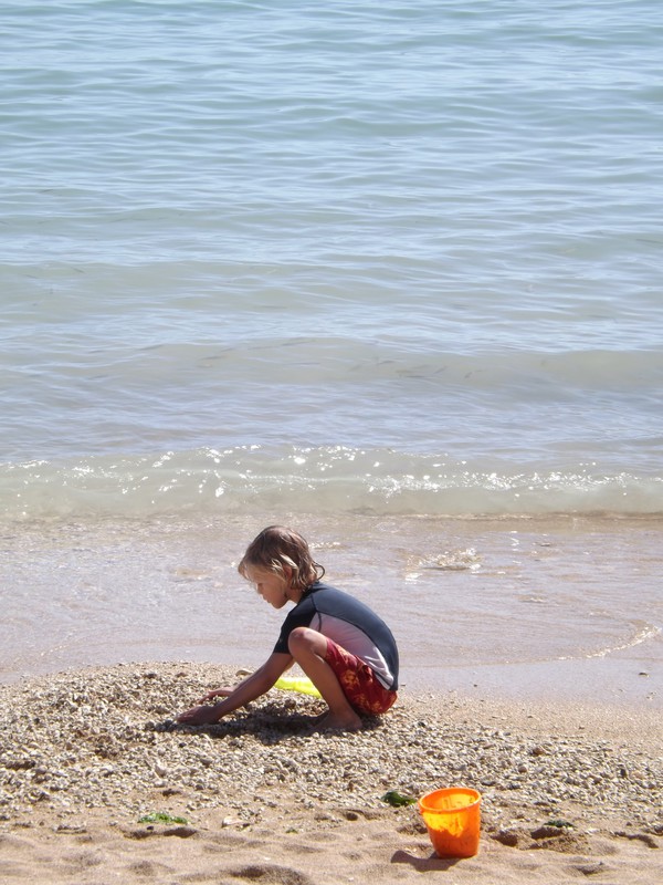 Child Building A Sand Castle