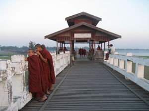 Monks at sunset on U Bien's bridge