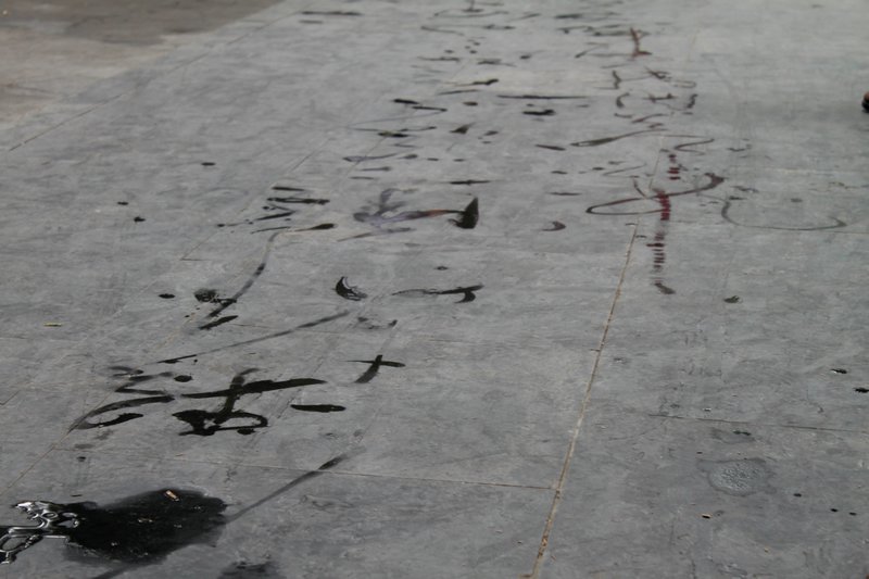 Caligraphy painted in water on the pavement at the Summer Palace