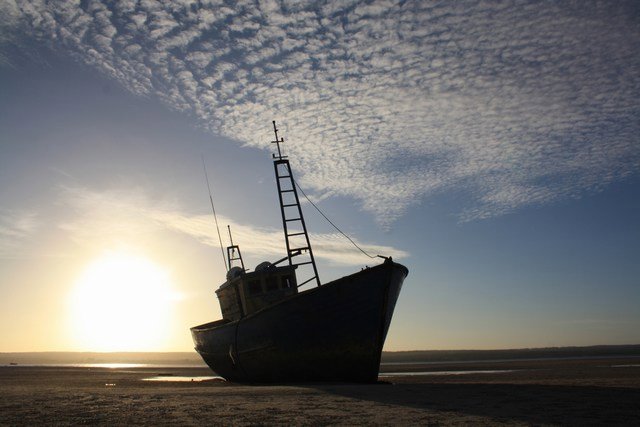 Stranded boat in the sunset
