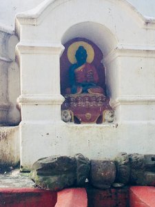 Different representations of Buddah encircle this smaller stupa.