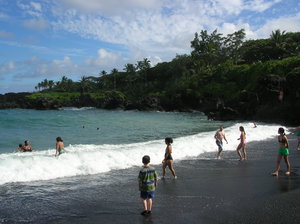 Swimmers at the black sand beach