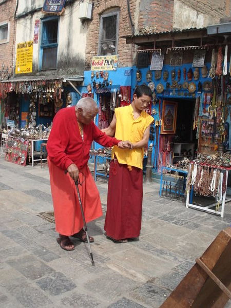 a young monk lending a hand