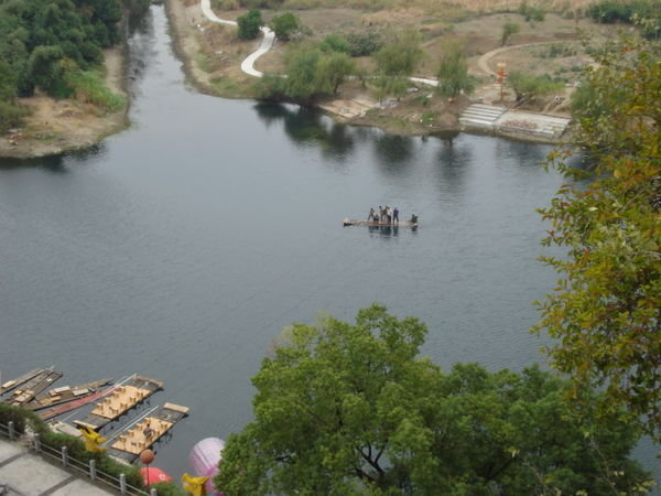Men crossing river on raft