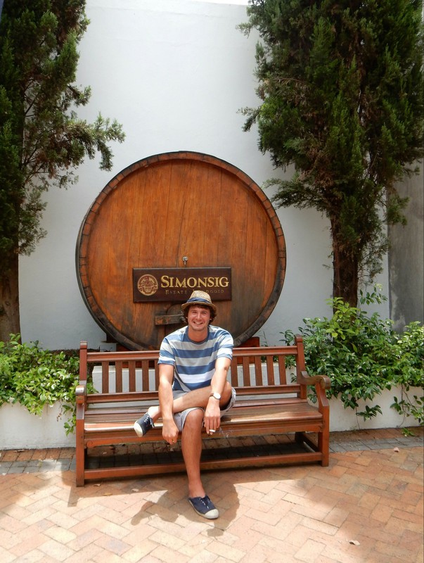 Maxime in front of an oaken barrel 