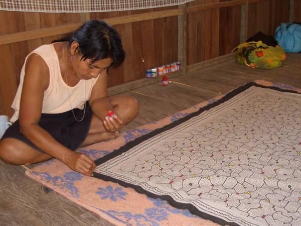 elisa making traditional cloth-paintings