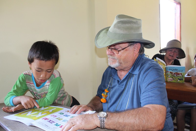 Hmong children get help from  Americans.