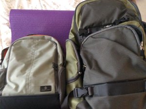 Small travel backpack next to full size backpack