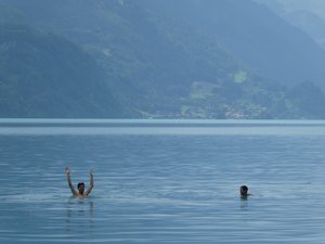 Guys swim in Lake Thun