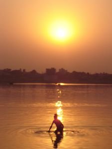 Baba bathing at sunset in the ganga