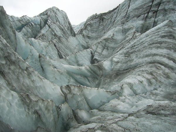The leaning shape of the glacier indicates how it is advancing