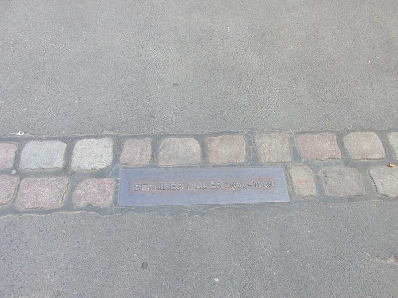 The path of the Berlin Wall is marked along the city streets.