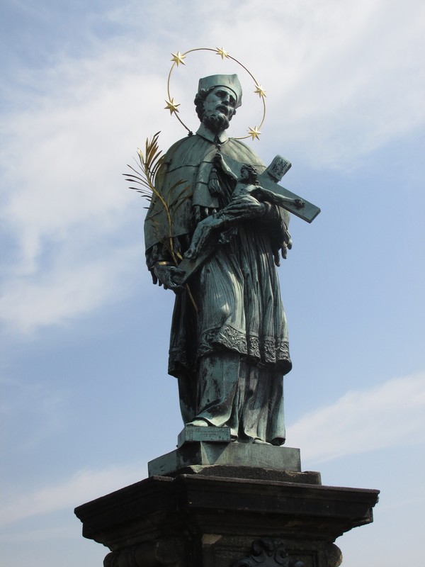 Statue of St John of Nepomuk on the Charles Bridge. In 1393 King Wenceslaus had John thrown into the Vltava river from the Charles Bridge.
