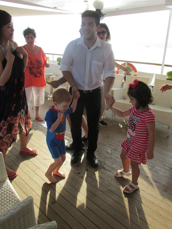 Dancing with his new friends on board.