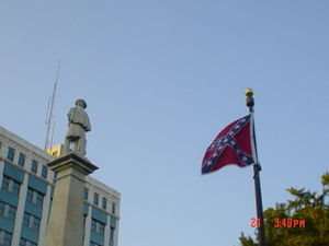 Statue with back turned towards the Confederacy Flag
