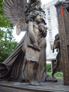 Little angel on the women's statue