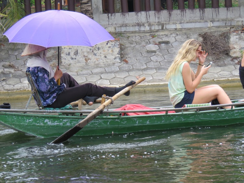 Rowing with feet - leaves hands free for parasol! 