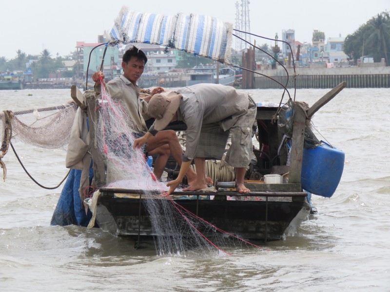 Fishermen on the Mekong bringing in their nets 