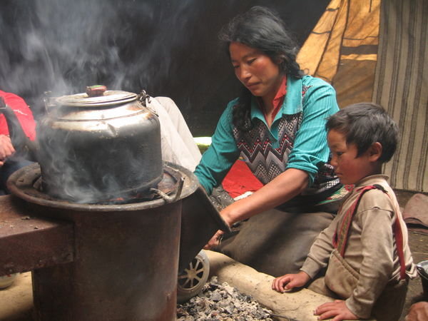 Tibetan mother and son cooking us lunch