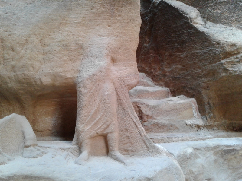 Ancient figures carved in the rock face acknowledged travelers before they arrived at the Treasury