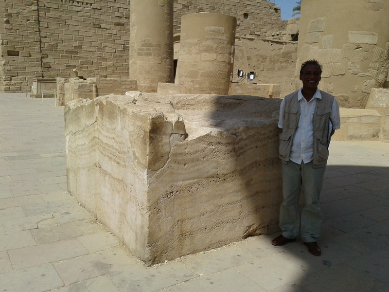 Ahmad my Egyptologist guide from Luxor is dwarfed by one stone block in the temple compound