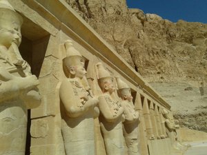 Giant carved figures of Pharaoh Hatshupset stand the front columns of the Holy of Holies in the Valley of the Kings
