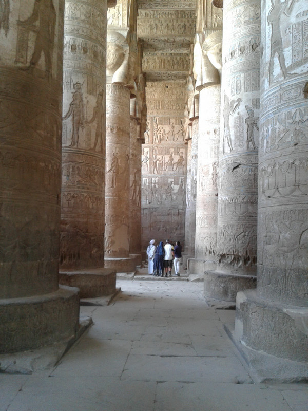 The Giant pillars at Hathor temple tower above visitors