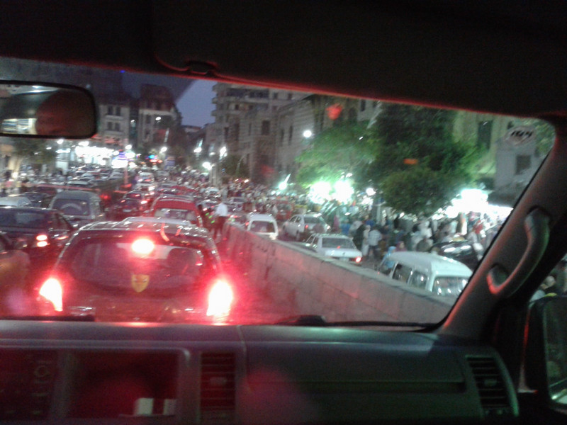 Cairo streets at night, traffic chaos. Cars were honking horns at the traffic police.  