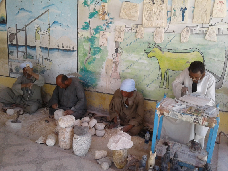 alabaster workers demonstrate their craft at the entrance door to the Alabaster factory in Luxor