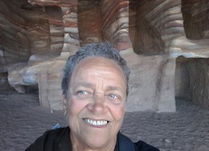 Petra cave selfie with layered rocks
