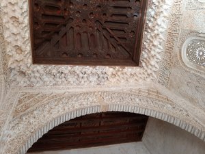 Intricate wood and stucco ceilings at the Court of the Lions include Koranic verse and elements of nature