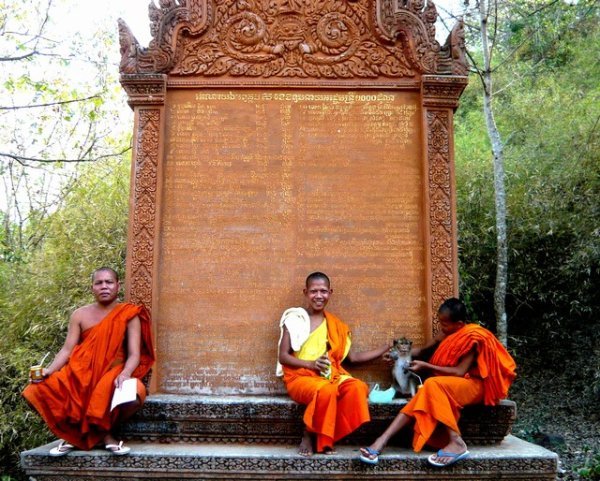 Monks playing with monkey