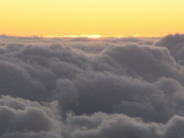 The sun coming up through the clouds on Haleakala on Maui.