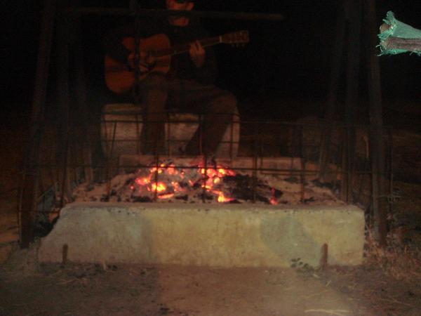 Playing guitar by the camp fire