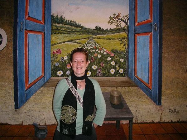 Kerensa in front of a fun painting in Cuenca