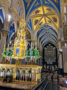 Golden altarpiece and the ceiling and pews of the Basilica