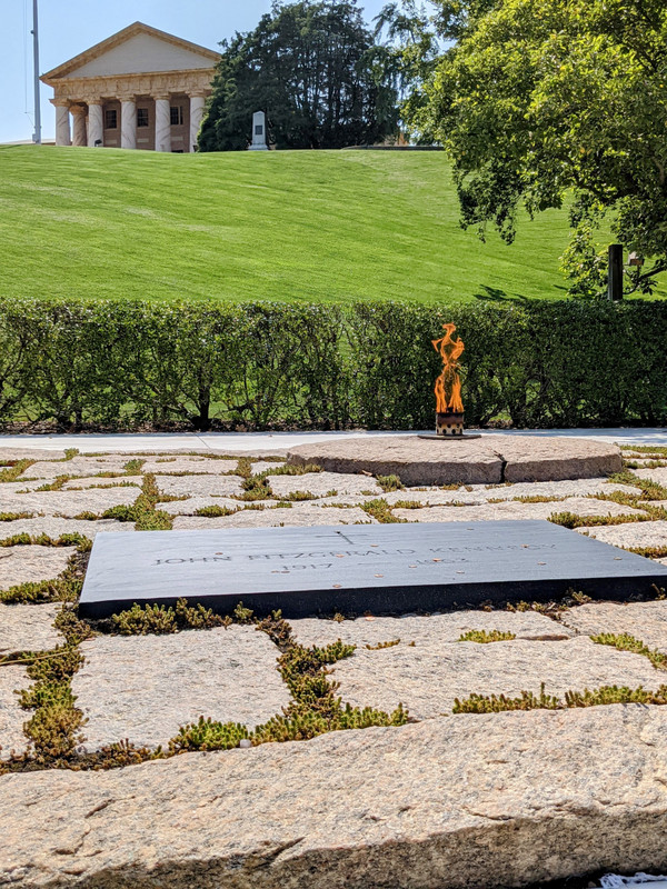 The eternal flame at the grave of JFK (and the Arlington House at the top of the hill)