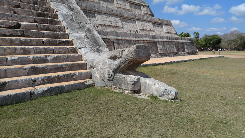 Kukulkan's serpent face at the base to the steps up the Castillo