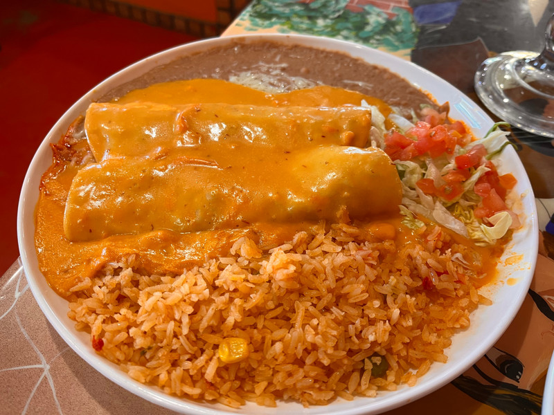 Chicken chipotle enchiladas with rice and beans