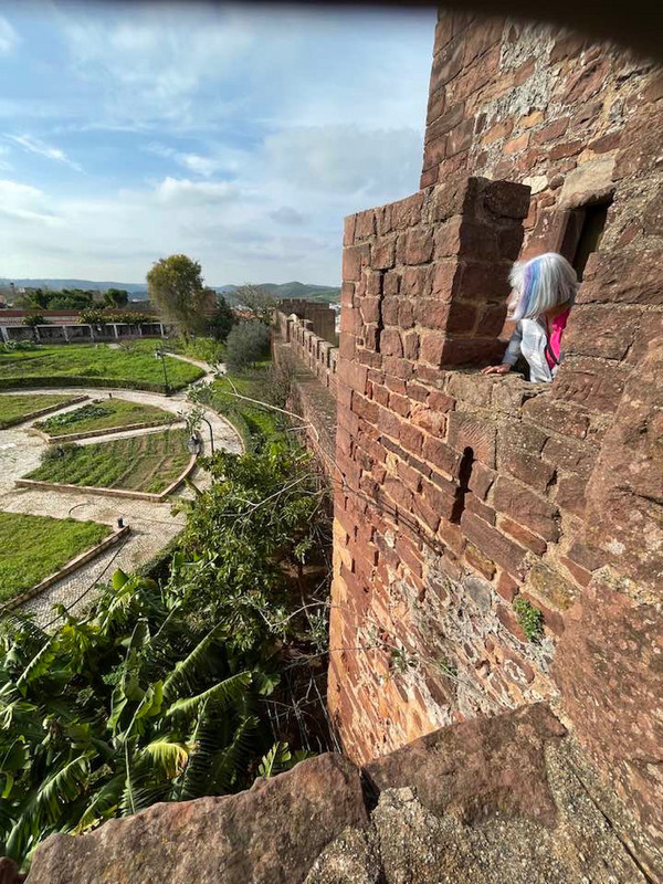 me looking out the window at Silves Castle