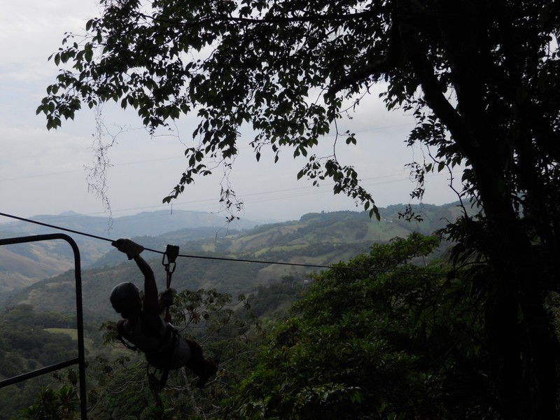 One of our zip-lining colleagues settings out on one of the whopping lines across the valley below.