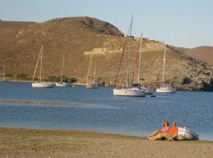 Deck-chairs on the sand with a bottle of sparkly at sunset - Kythnos