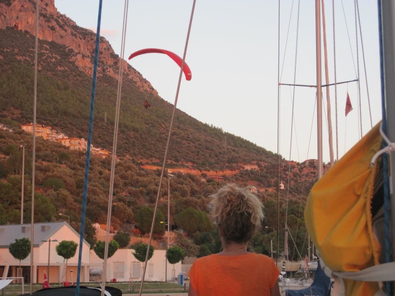 Kate watching a paraglider coming in to land, Kas marina
