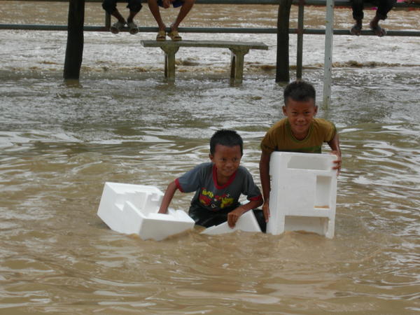 Cambodian children making the most of the flood waters